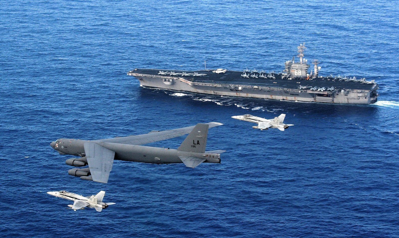 A B-52 and Navy Hornets near USS Nimitz